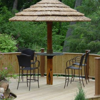 bamboo panels combined with seating around african thatch umbrella