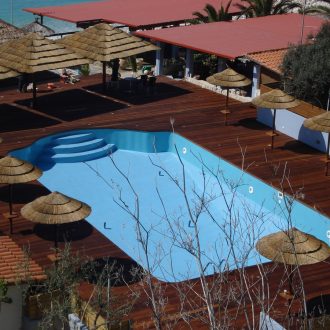 cape reed umbrellas around a pool