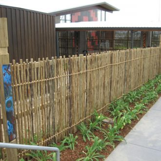 eucalyptus fencing outdoors around a building